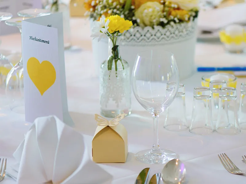 Hochzeitskarten und eine Papierschachtel auf einem gedeckten Tisch